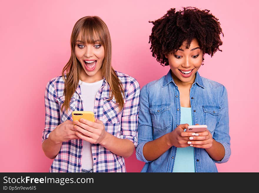 Portrait of her she two person nice-looking cute attractive charming cheerful girls wearing casual using device gadget app 5g wi-fi connection over pink pastel background.