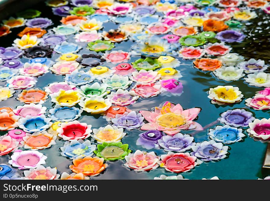 Flowers floating candles in whirlpool represent a sacred fortification