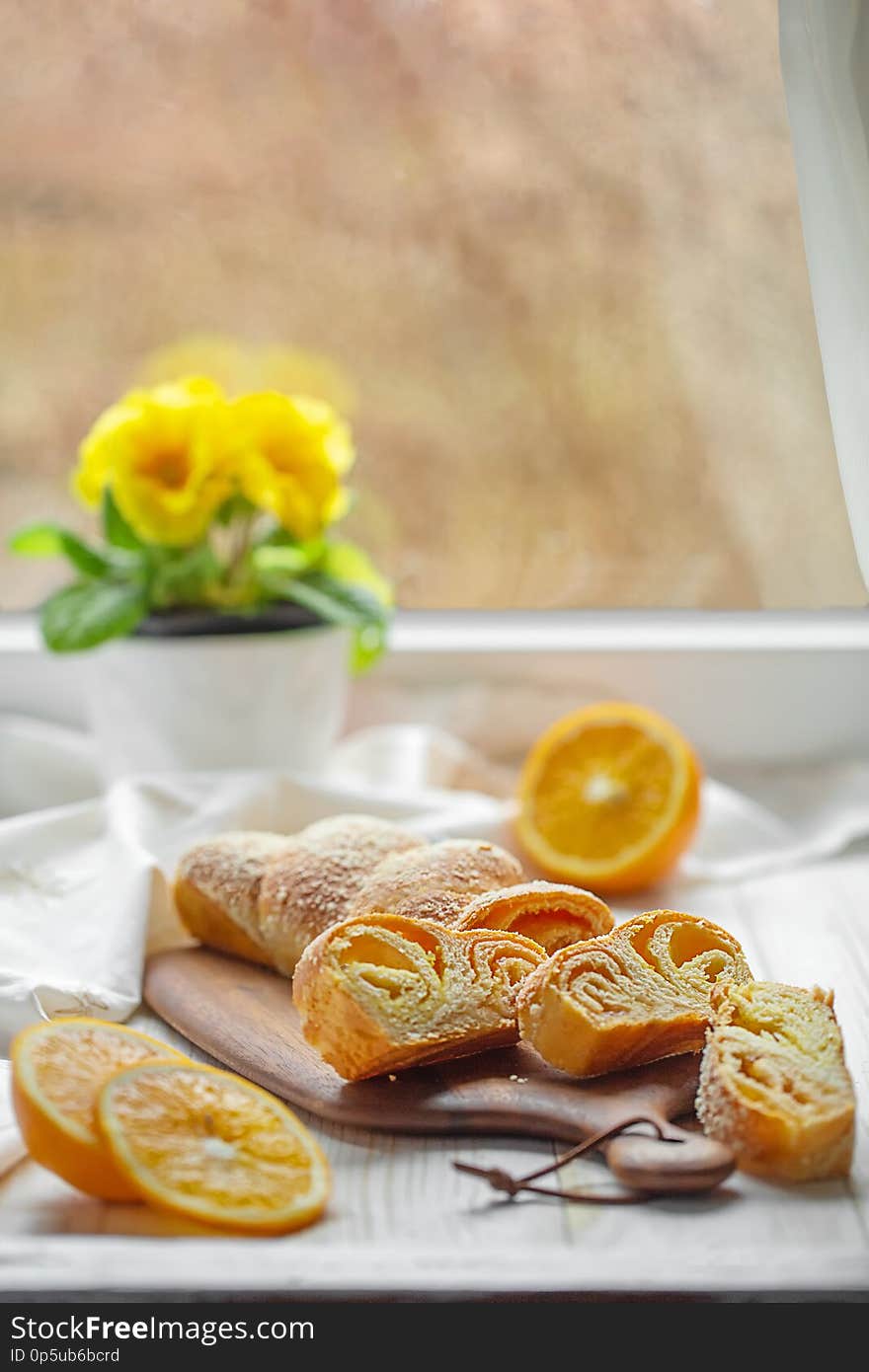 Orange strudel with powdered sugar and orange