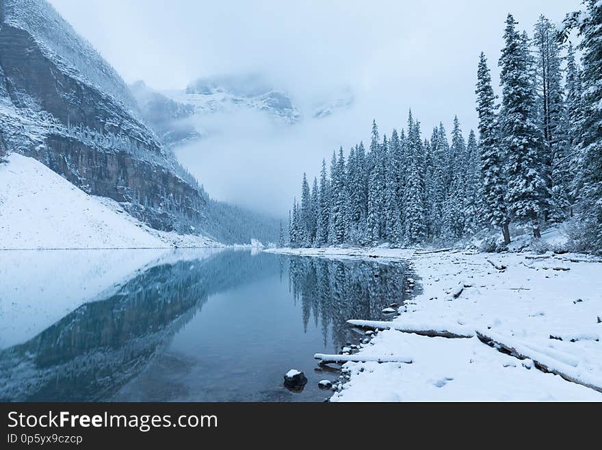 First snow Morning at Moraine Lake in Banff National Park Alberta Canada Snow-covered winter mountain lake in a winter atmosphere.