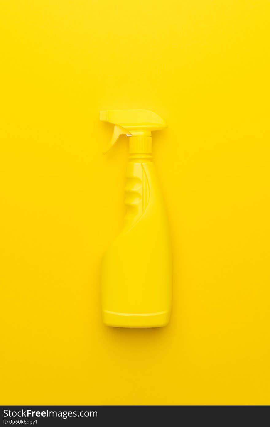 Yellow cleaning spray on the yellow background
