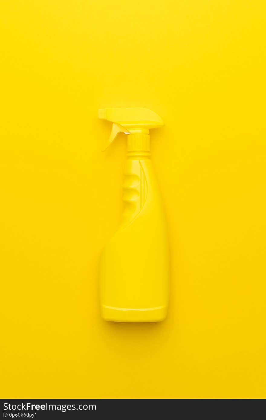 Yellow cleaning spray on yellow background