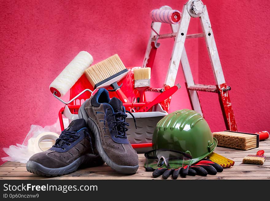 Safety equipment. Work shoes, gloves, helmet and goggles on an aged wooden table. Construction industry. Building. Safety equipment. Work shoes, gloves, helmet and goggles on an aged wooden table. Construction industry. Building