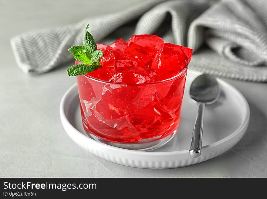 Delicious red jelly in glass on light table