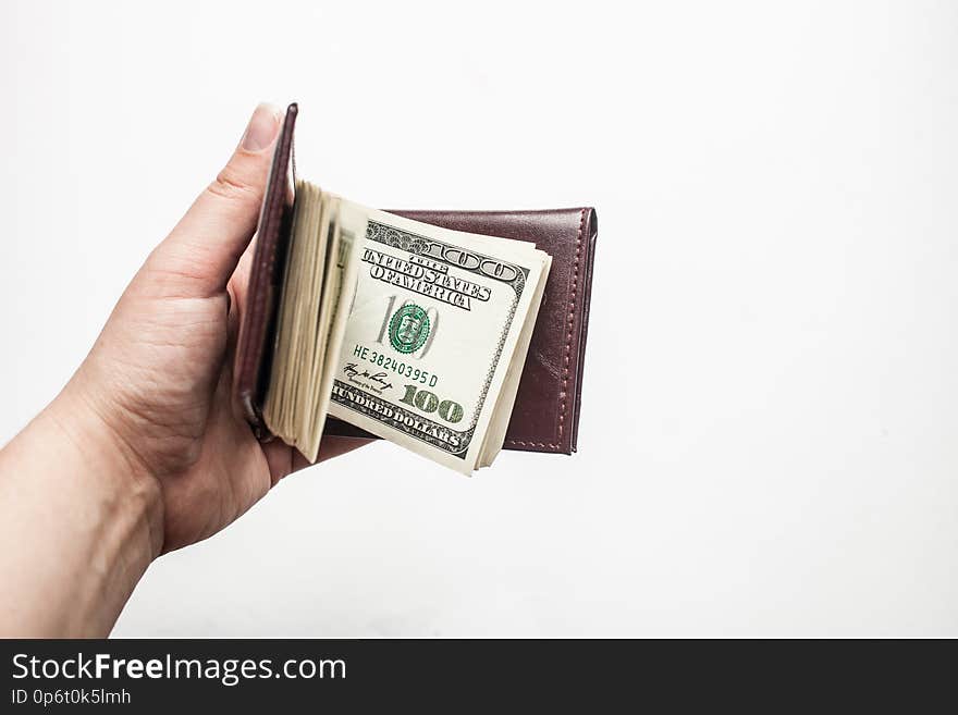 Women hand holding a wallet full of one hundred dollar bills isolated over a white background