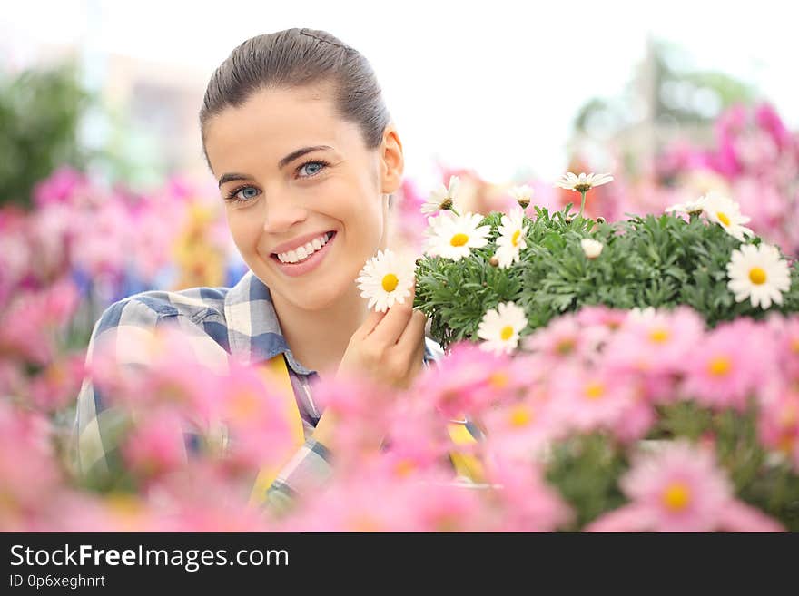 Spring concept, smiling woman in the garden of flowers