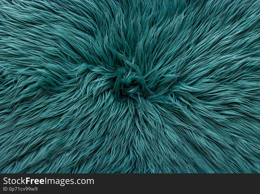 Blue green almost turquoise fake fur rug pattern. centered going out of frame of the image. Photo evenly lit with minimal shadow. Blue green almost turquoise fake fur rug pattern. centered going out of frame of the image. Photo evenly lit with minimal shadow.