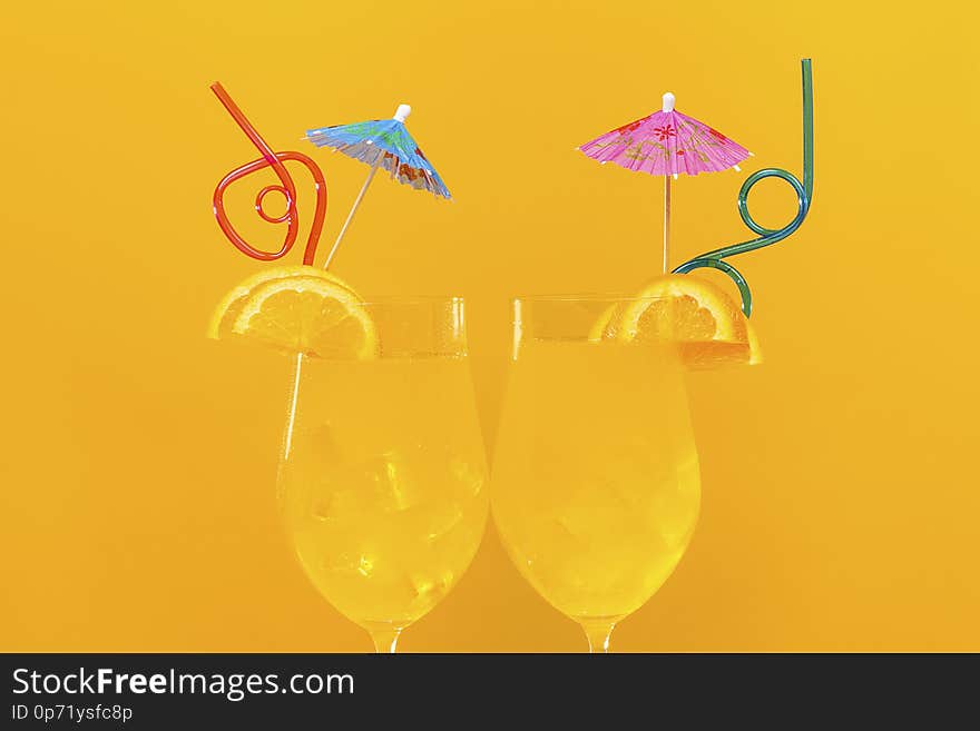 Two orange cocktails on an orange background, concept cool drink in summer. Two orange cocktails on an orange background, concept cool drink in summer