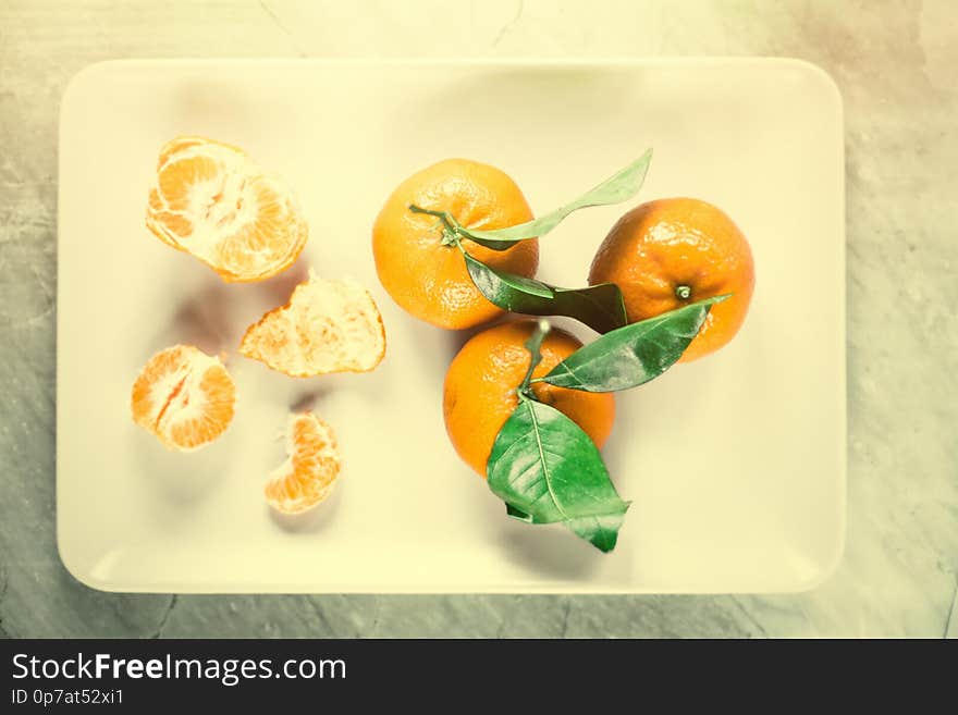 Ripe juicy mandarines in vintage style - retro still life and healthy nutrition concept. Tangerine delight