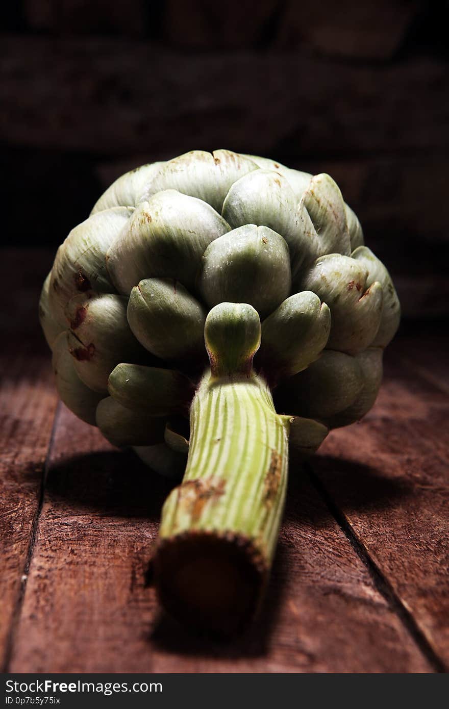 Artichokes on rustic background. fresh organic artichoke flower set