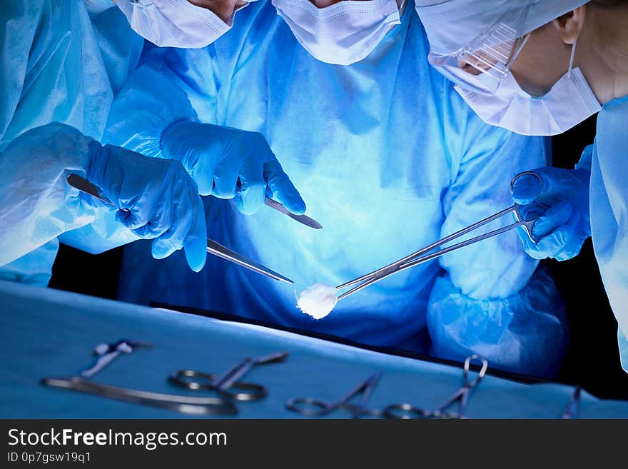 Group Of Surgeons In Masks Performing Operation. Medicine, Surgery And Emergency Help Concepts