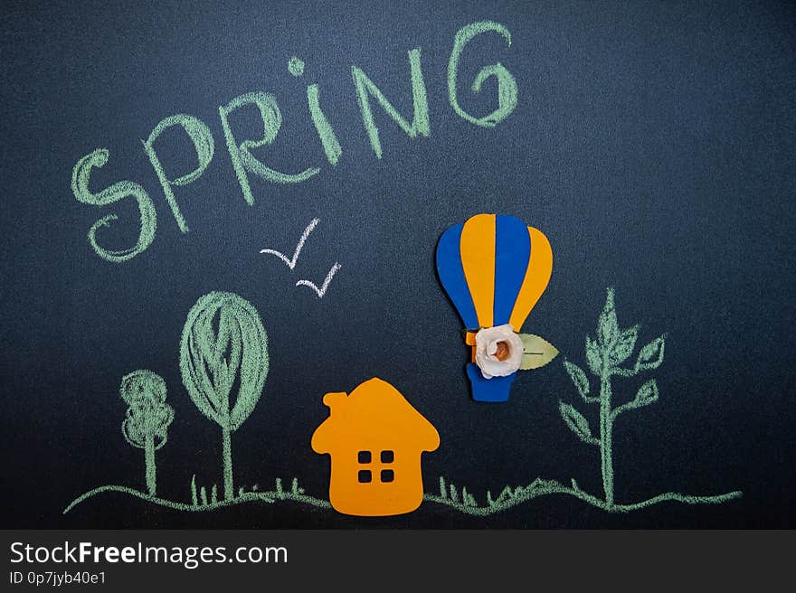 Funny composition on the theme of spring in a cartoon style, house, forest and a balloon with flowers