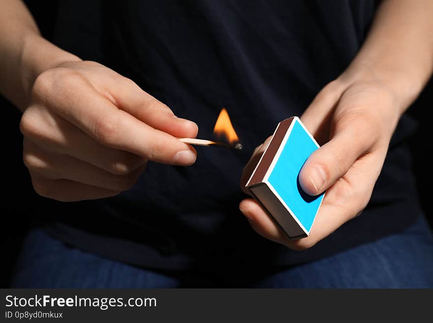 Woman with box of matches, closeup of hands