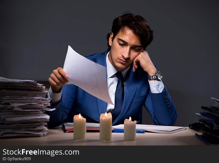 The businessman working late in office with candle light