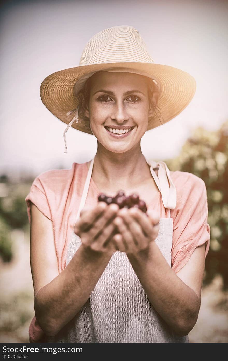 Portrait Of Smiling Farmer Holding Red Grapes