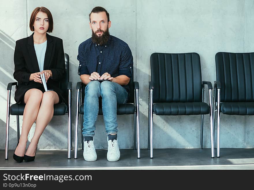 Nervous applicants waiting interview. Job recruitment. Corporate hiring. Woman and men feeling stressed. Nervous applicants waiting interview. Job recruitment. Corporate hiring. Woman and men feeling stressed.