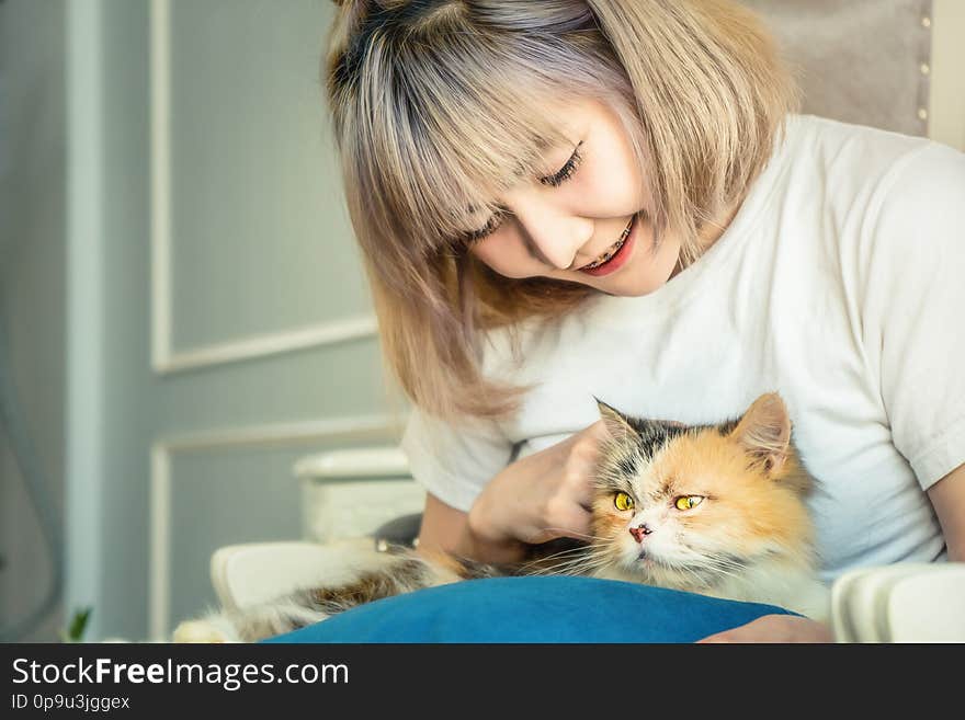 Portrait of Asian female playing with cute cat