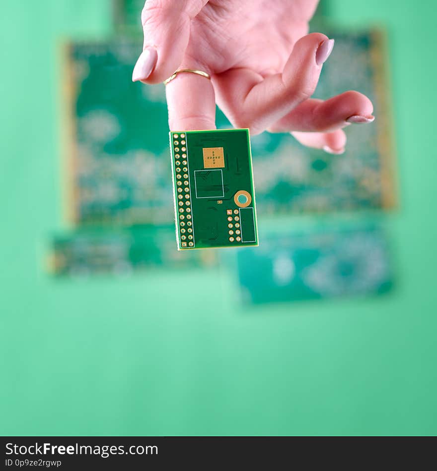 Small Electronics Circuit Boards on human woman finger. The woman technician hand. The concept of computer, service, electronics, hardware, repairing, upgrade and technology. Small Electronics Circuit Boards on human woman finger. The woman technician hand. The concept of computer, service, electronics, hardware, repairing, upgrade and technology.