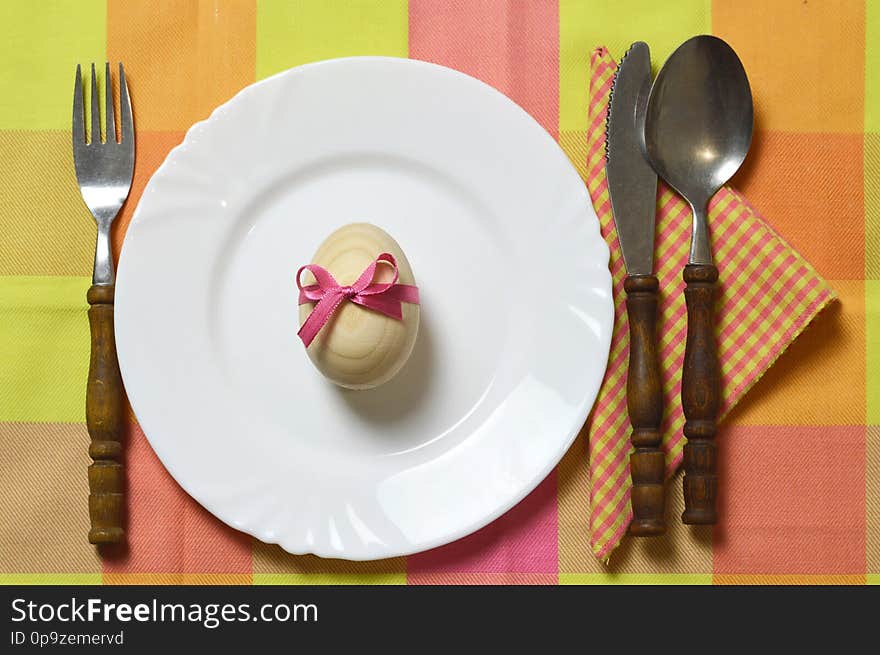 Easter table setting. Top view of Easter egg, plate and cutlery. Easter table setting. Top view of Easter egg, plate and cutlery