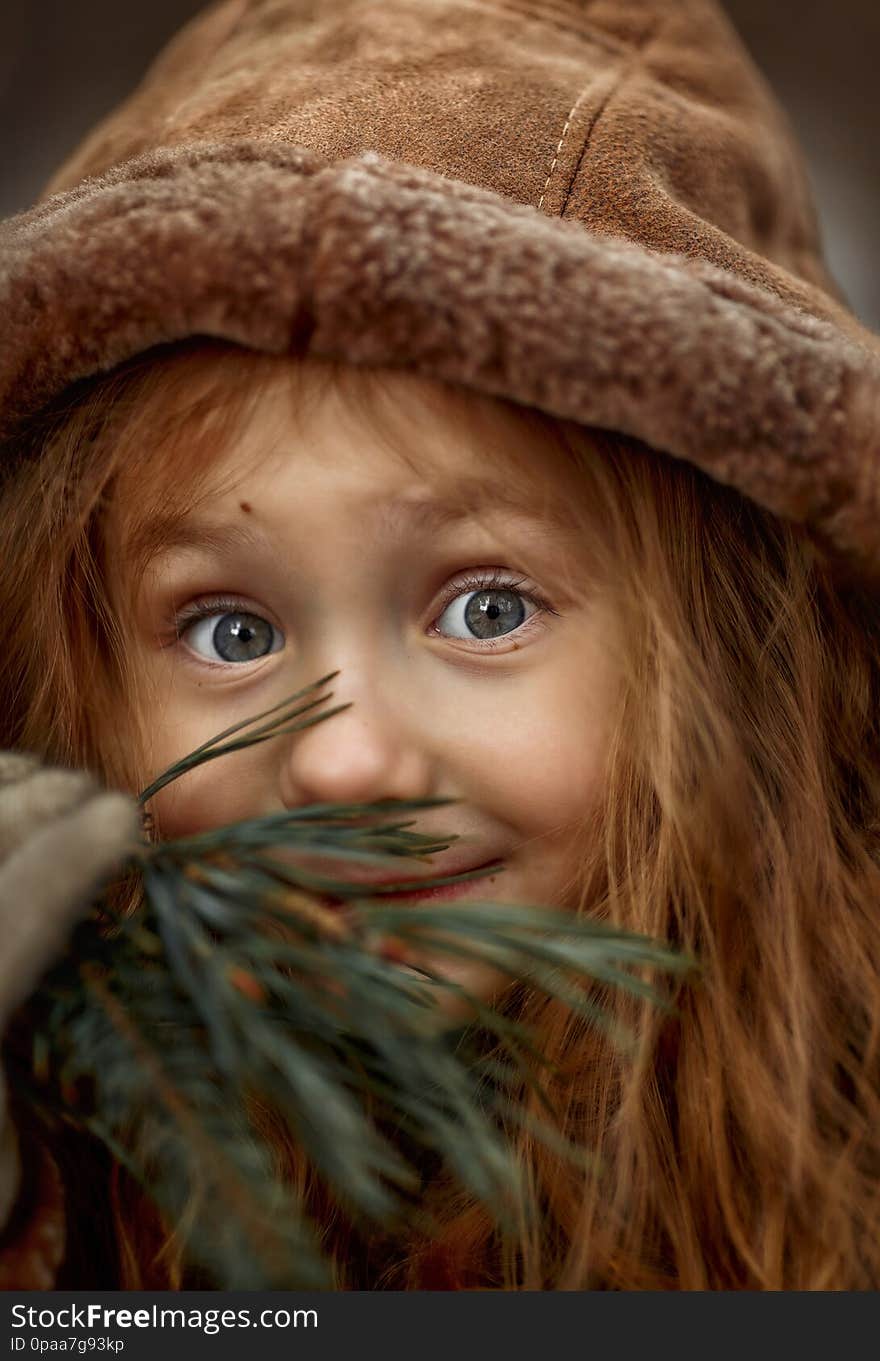 Cute little girl portrait in a spring forest at cloudy day