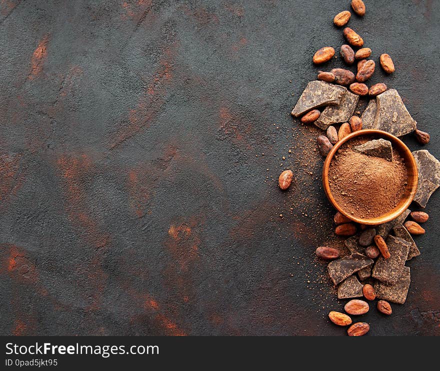 Natural  cocoa powder and cocoa beans  on a black background. Natural  cocoa powder and cocoa beans  on a black background