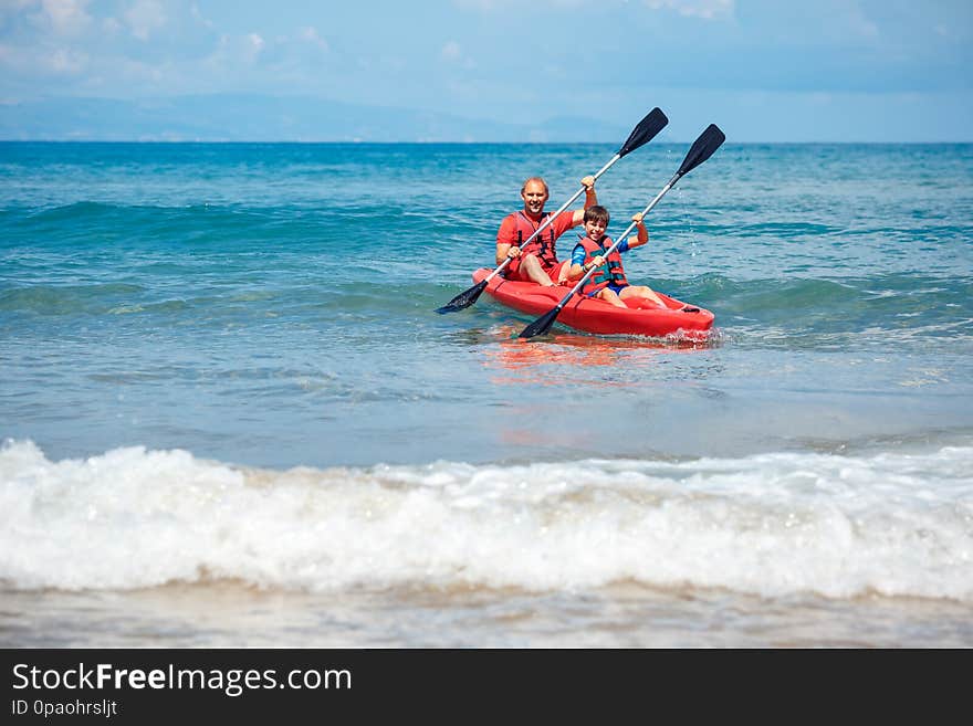 Father and son kayaking in ocean. Active vacation with young kid. Holiday activity with schoolboy child. Family summer fun
