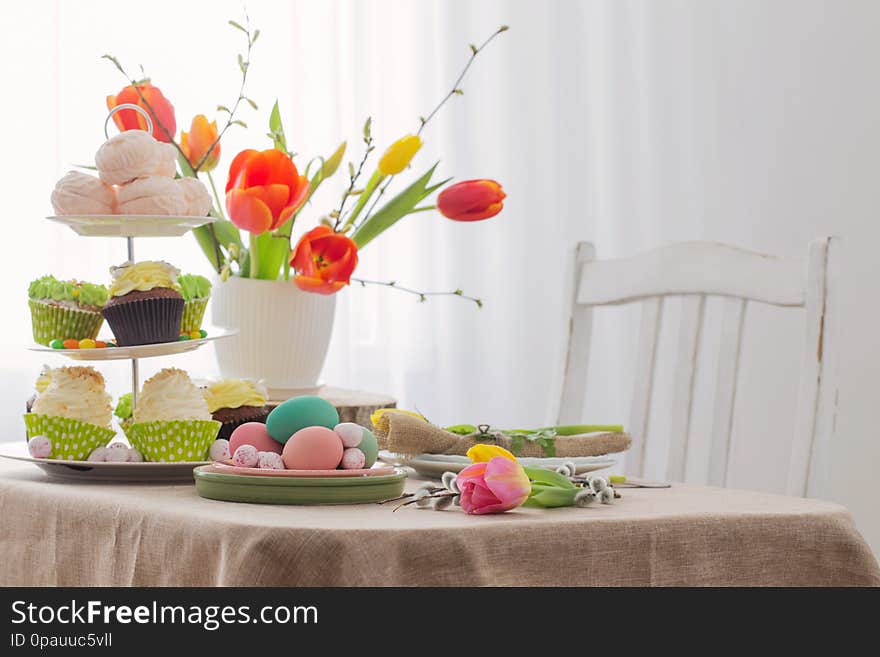 Easter table with tulips and decorations in white interior