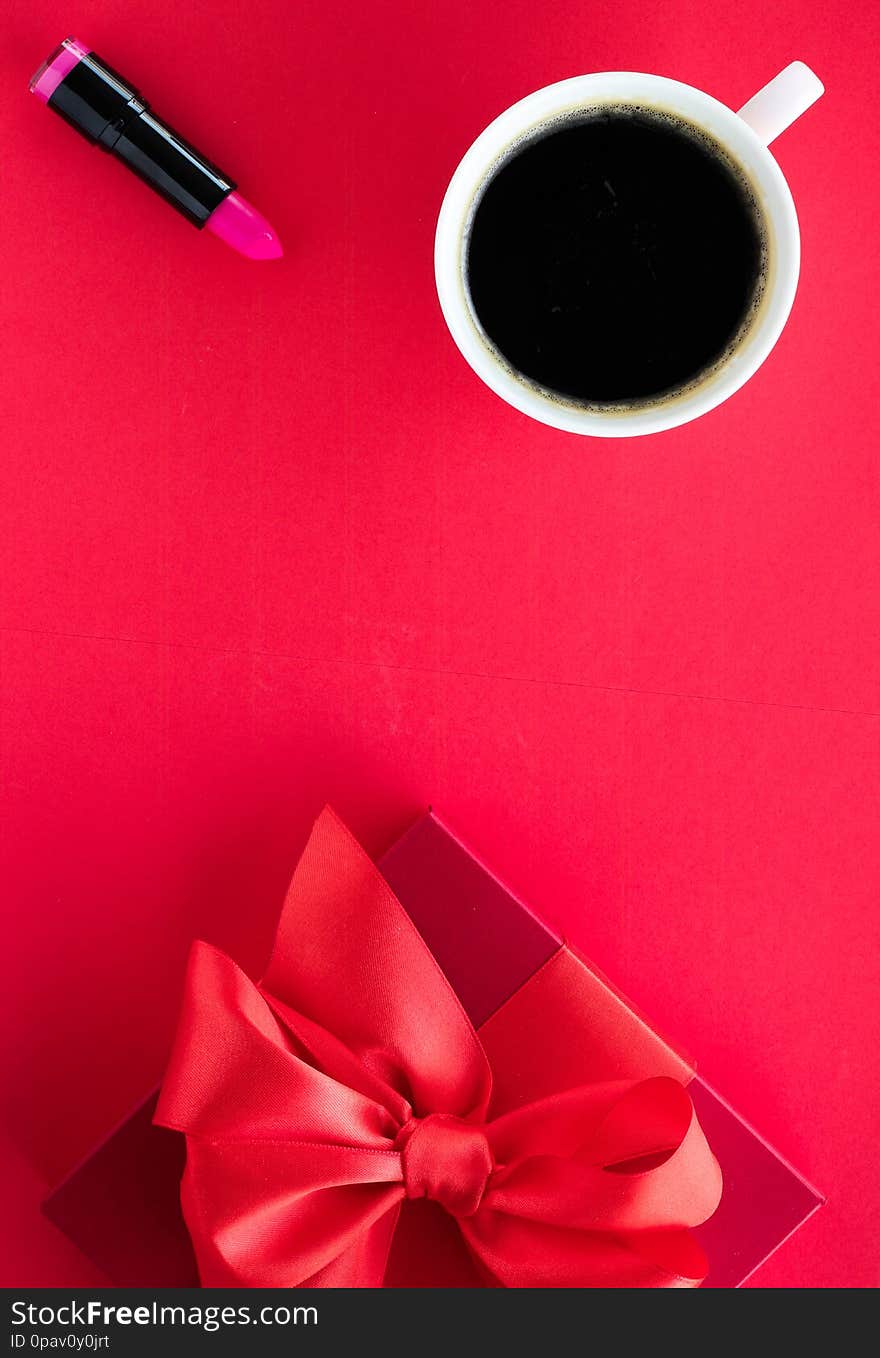 Luxury beauty gift box and coffee on red, flatlay