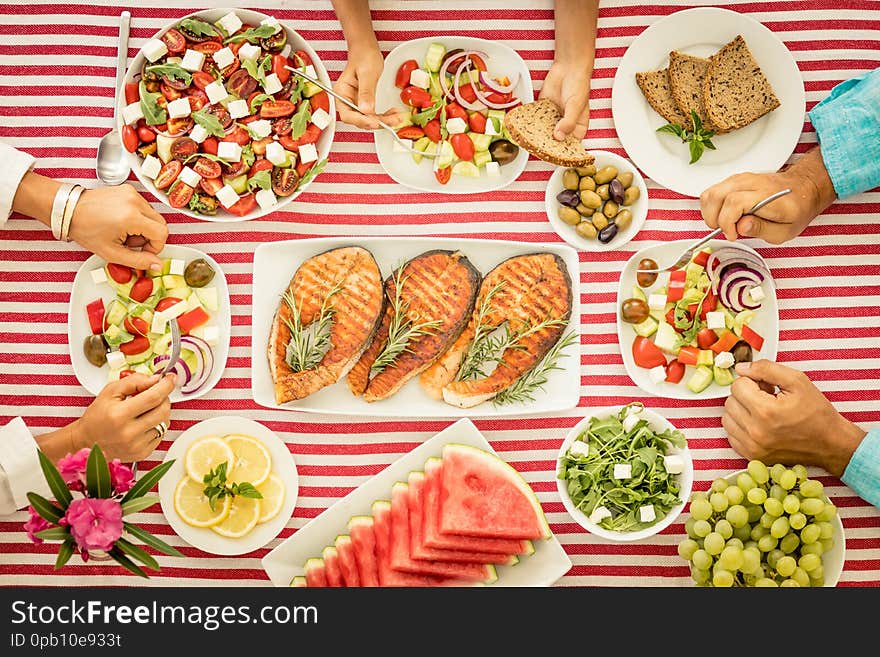 Top view of table with fish, salads, fruits and vegetables. Mediterranean diet. Healthy food concept. Top view of table with fish, salads, fruits and vegetables. Mediterranean diet. Healthy food concept