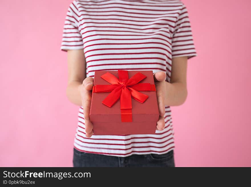 The girl holds a gift in her hands