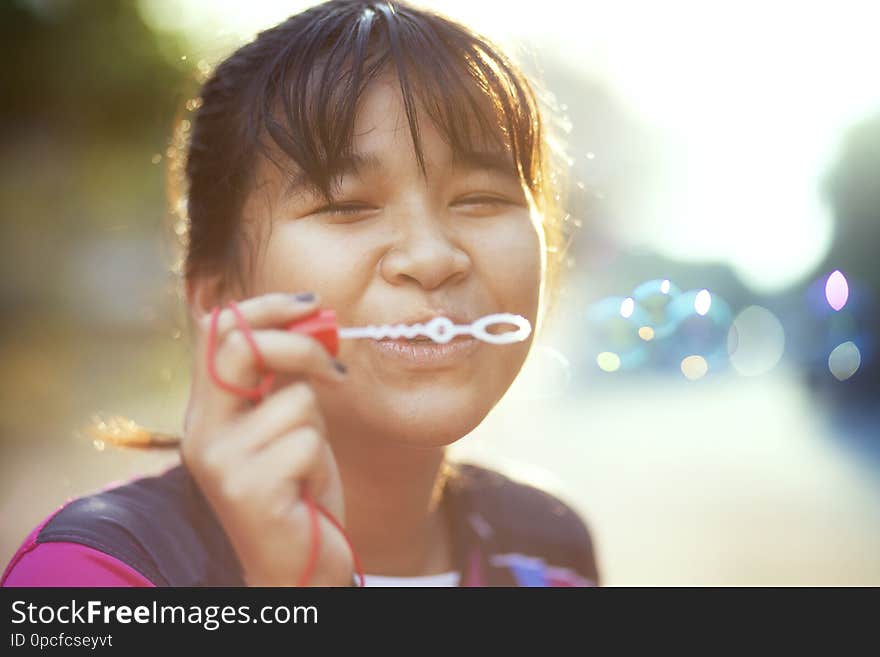 Asian teenager relaxing   with soup bubble against beautiful sun light