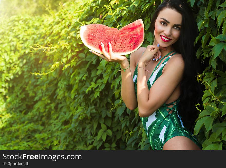 Smiling woman with slice watermelon