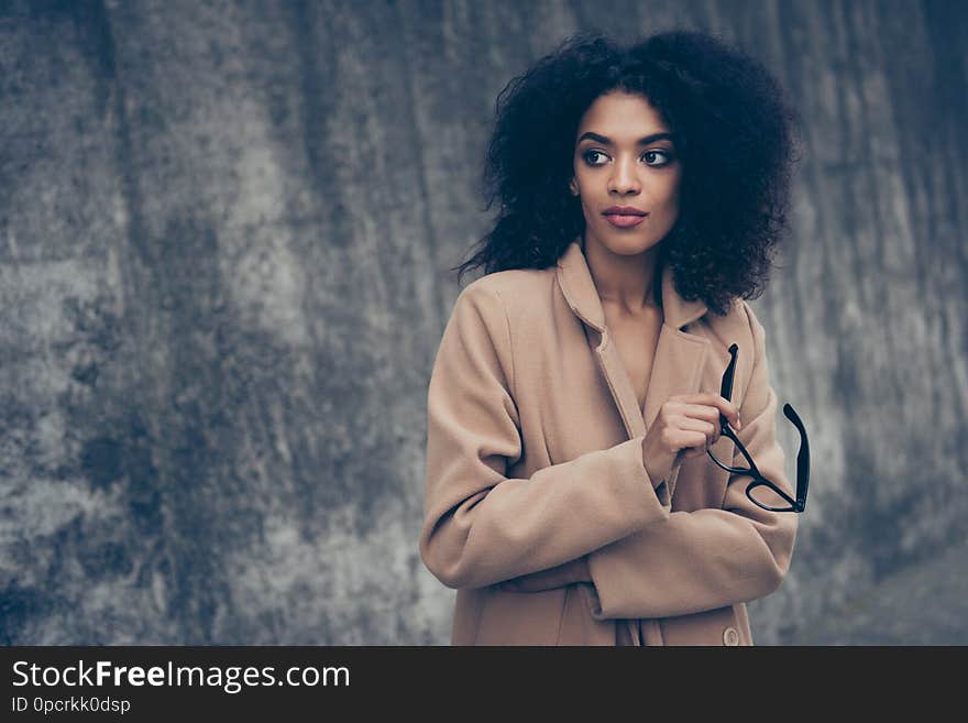 Portrait of minded nice cute confident gorgeous magnificent sweet lovely adorable pretty well-groomed feminine curly-haired lady in warm fall cosy beige clothes eyewear eyeglasses outside.