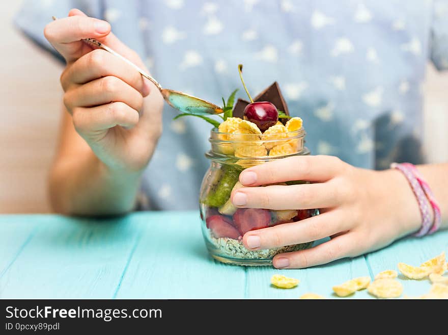 Healthy diet. girl hand with a spoon and oatmeal with berries and fruits. Healthy diet. girl hand with a spoon and oatmeal with berries and fruits