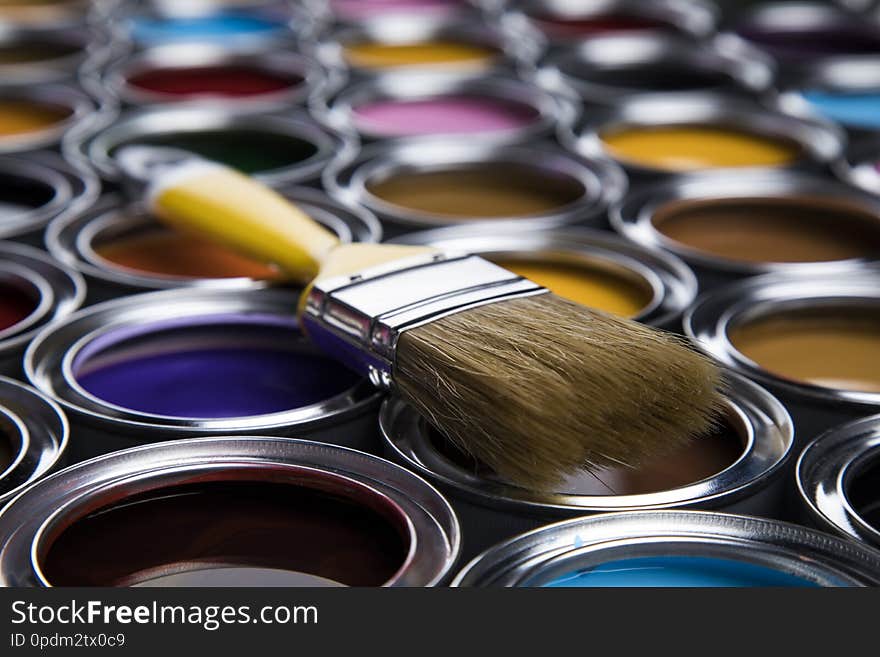 Tin cans with paint, brushes and bright palette of colors. Tin cans with paint, brushes and bright palette of colors