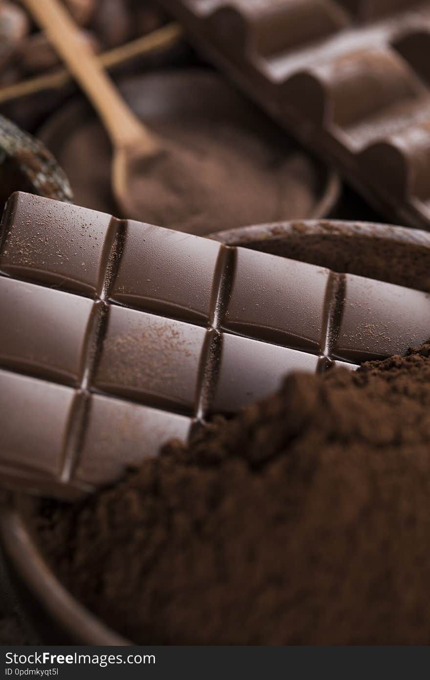 Milk and dark chocolate on a natural paper background. Milk and dark chocolate on a natural paper background