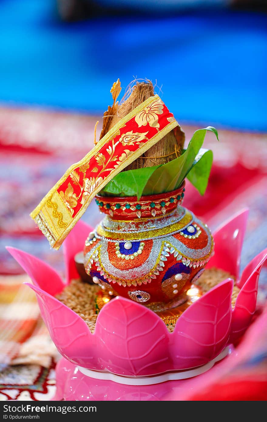 Copper kalash with coconut and mango leaf with floral decoration