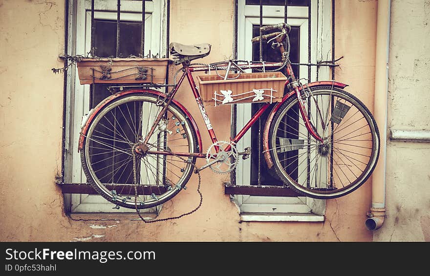 Old decorative bicycle on window. Warm filtered.