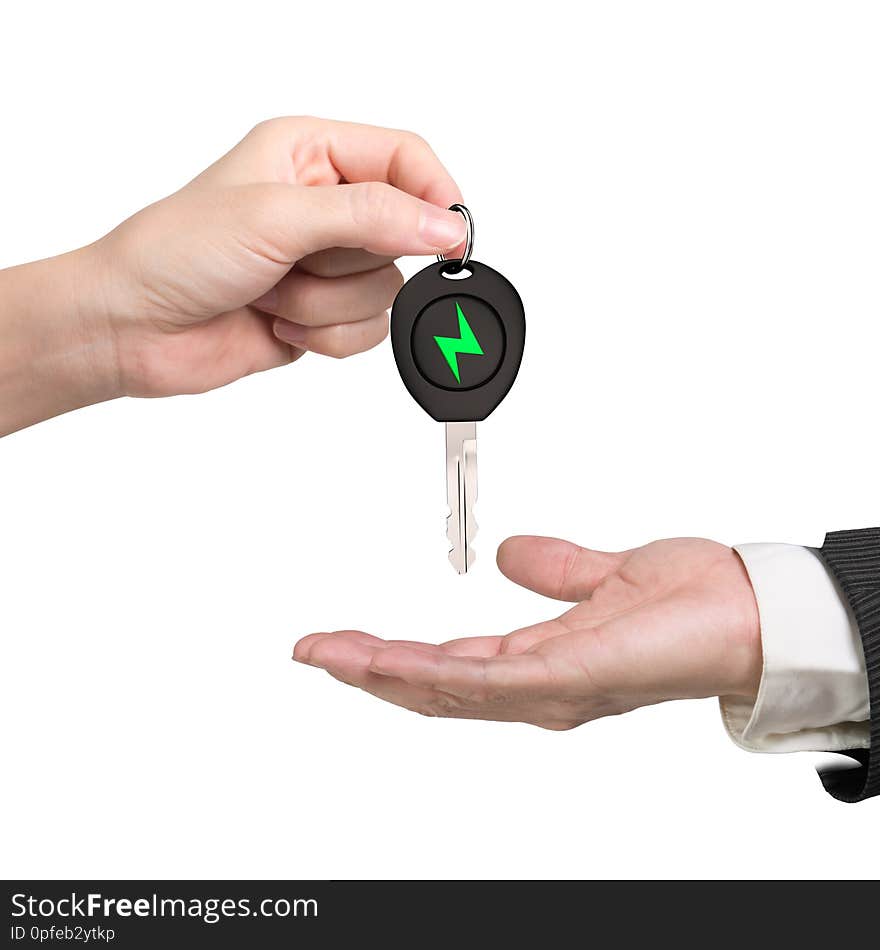 Green energy electric car and Eco-friendly environmental protection concept. Woman hand giving electric car key with green lightning bolt sign to man hand, isolated on white background. Green energy electric car and Eco-friendly environmental protection concept. Woman hand giving electric car key with green lightning bolt sign to man hand, isolated on white background