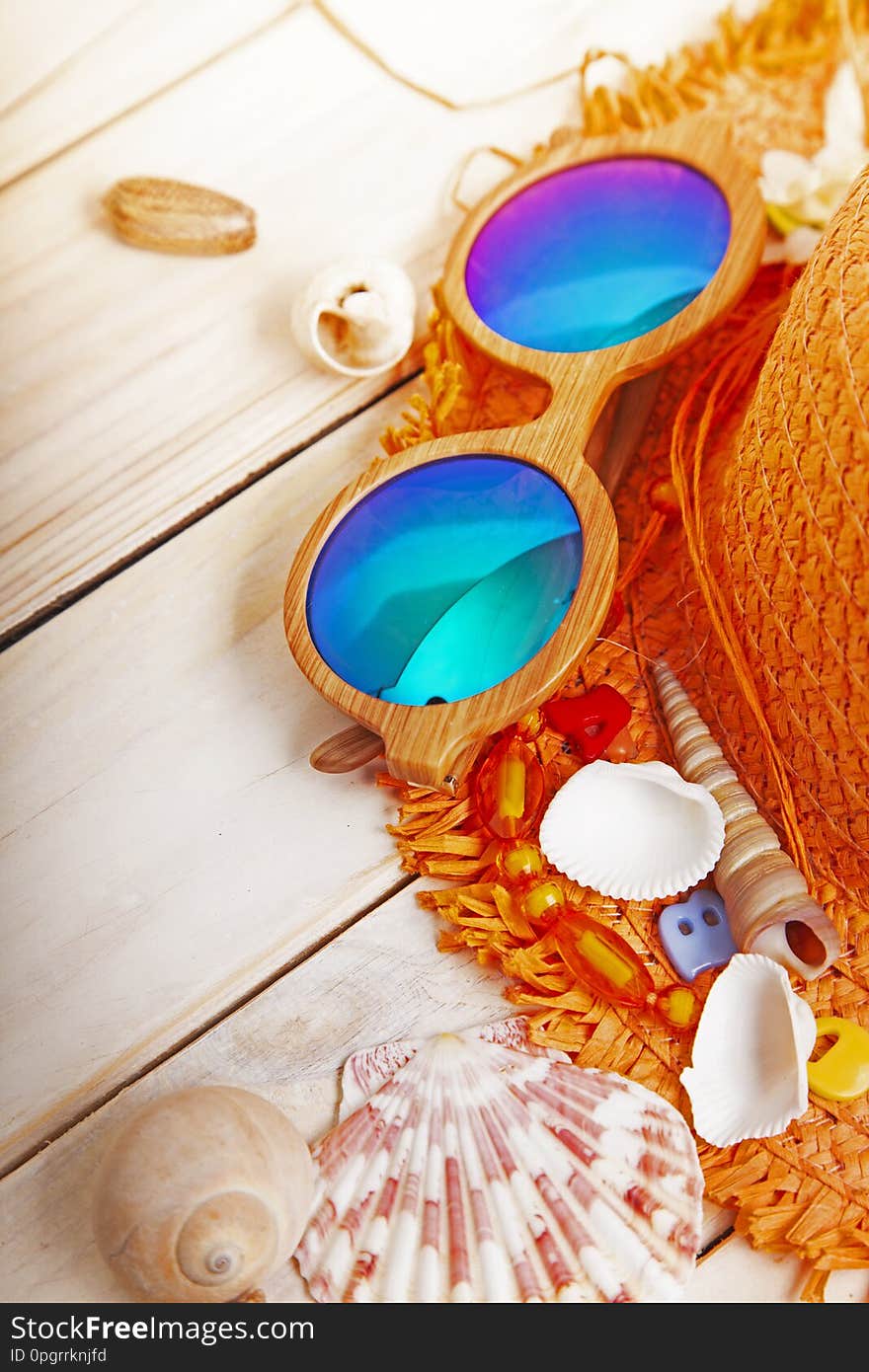 Beach accessories glasses hat cockleshells.