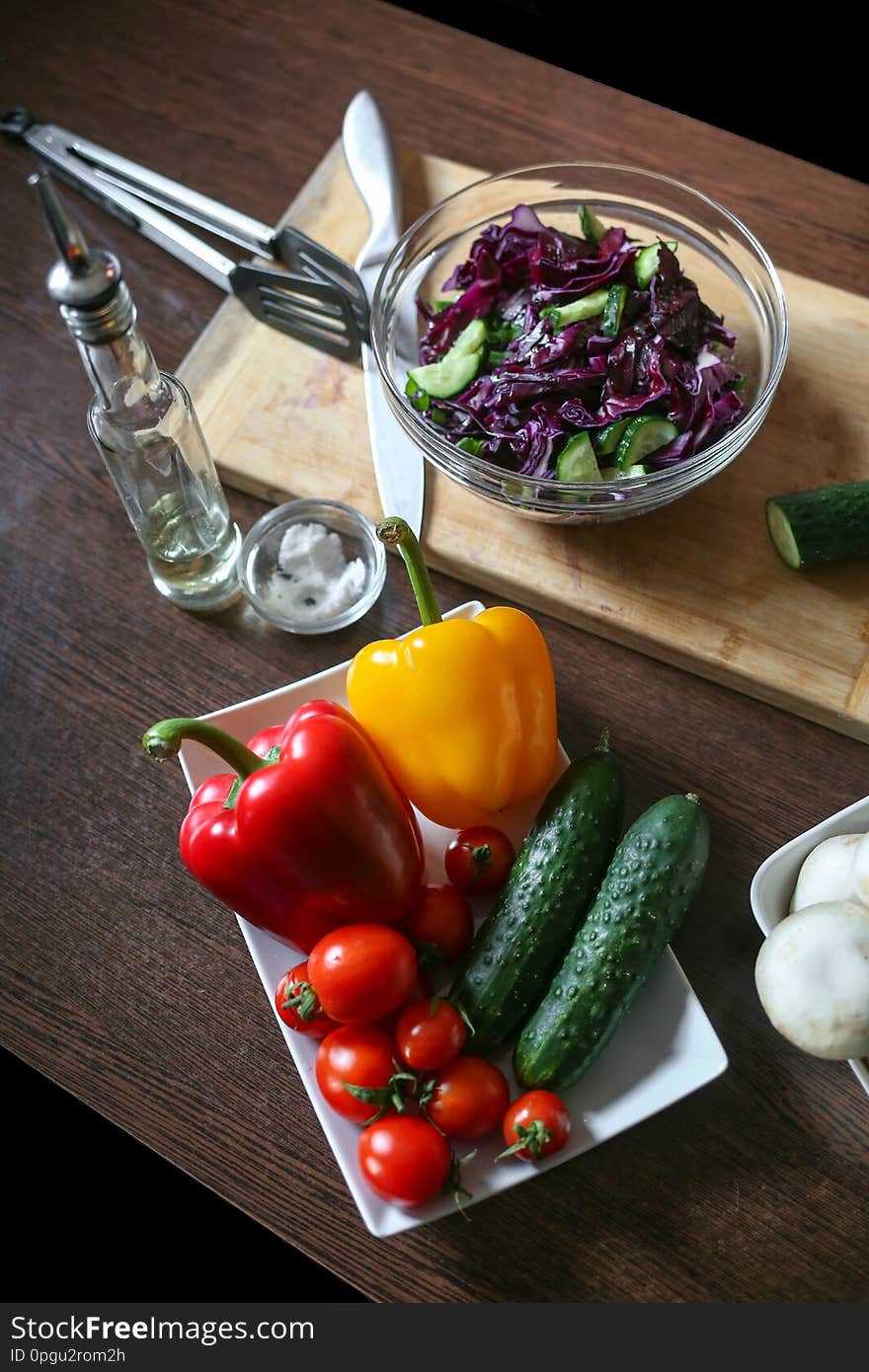 Cabbage salad and fresh vegetables are on the table. Vegetarian and healthy lifestyle. Vertically framed shot