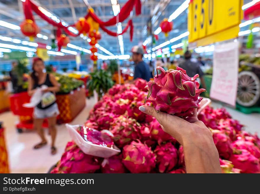 Woman Hand With Exotic Dragon Fruit On A Local Organic Food Market.