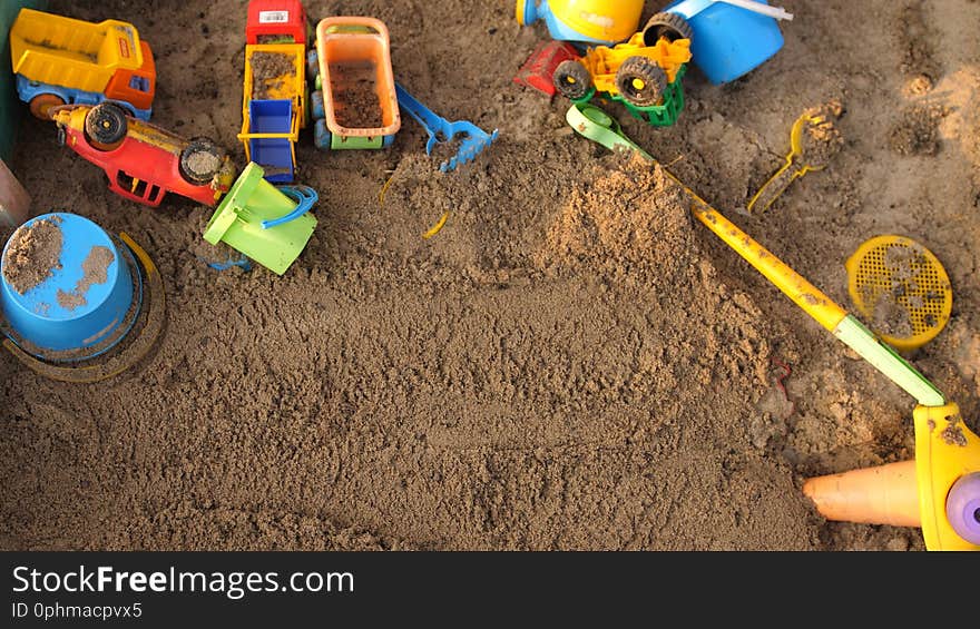 Top of view of a sandbox with toys on playground in sunny day