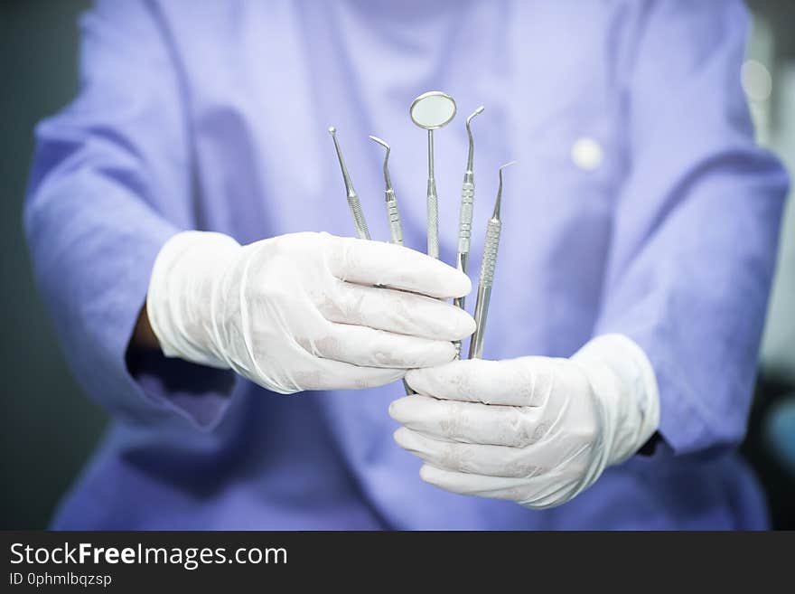 Close up Dentist holding dental equipment