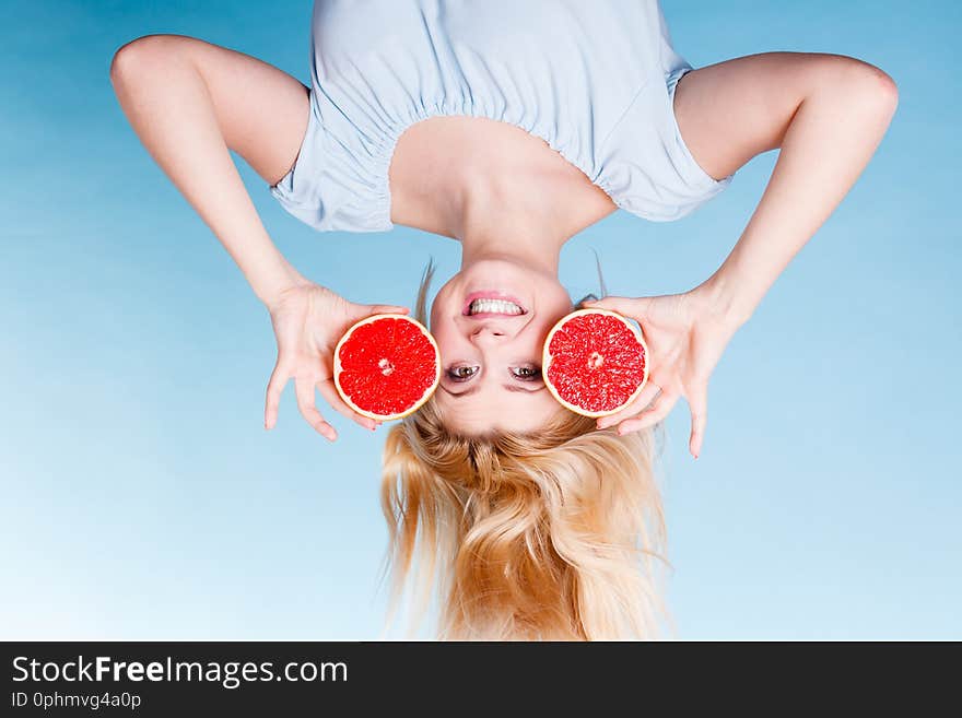 Healthy diet, refreshing food full of vitamins. Happy crazy woman holding sweet delicious citrus fruit, red grapefruit. Healthy diet, refreshing food full of vitamins. Happy crazy woman holding sweet delicious citrus fruit, red grapefruit