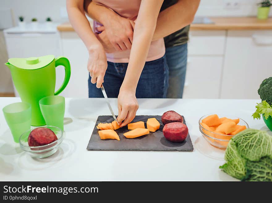 Cropped view of women hands cutting organic vegetables. Vegan loving family cooking fresh vegetables in the kitchen. Diet detox. Raw food diet. Vegetarian food. Cropped view of women hands cutting organic vegetables. Vegan loving family cooking fresh vegetables in the kitchen. Diet detox. Raw food diet. Vegetarian food