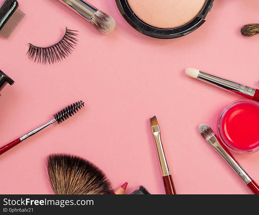 Set for professional makeup, different brushes for applying powder and eyeshadow. Cosmetics and Foundation, concept on pink background