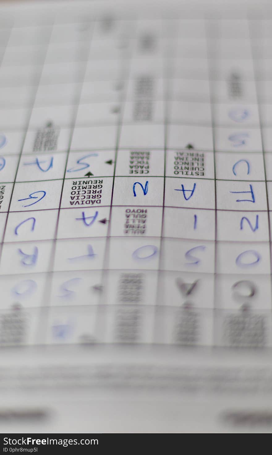 Crosswords puzzle`s notebook with letters and definitions in blue