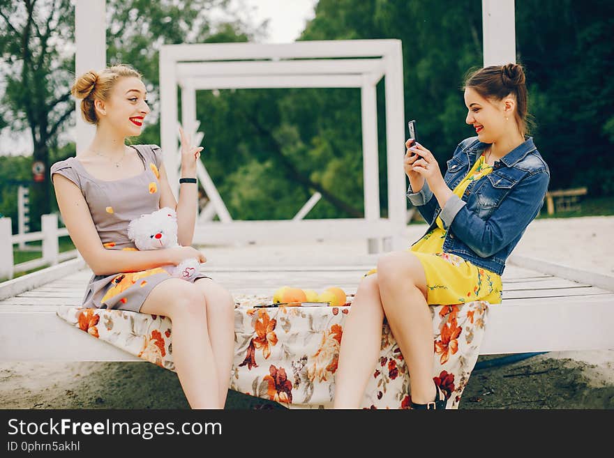 Two pretty girls in a summer park