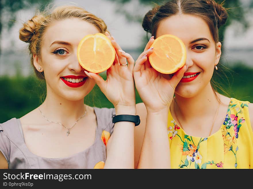 Beautiful girls on a beach. Friends have fun in a summer park. Beautiful girls on a beach. Friends have fun in a summer park.